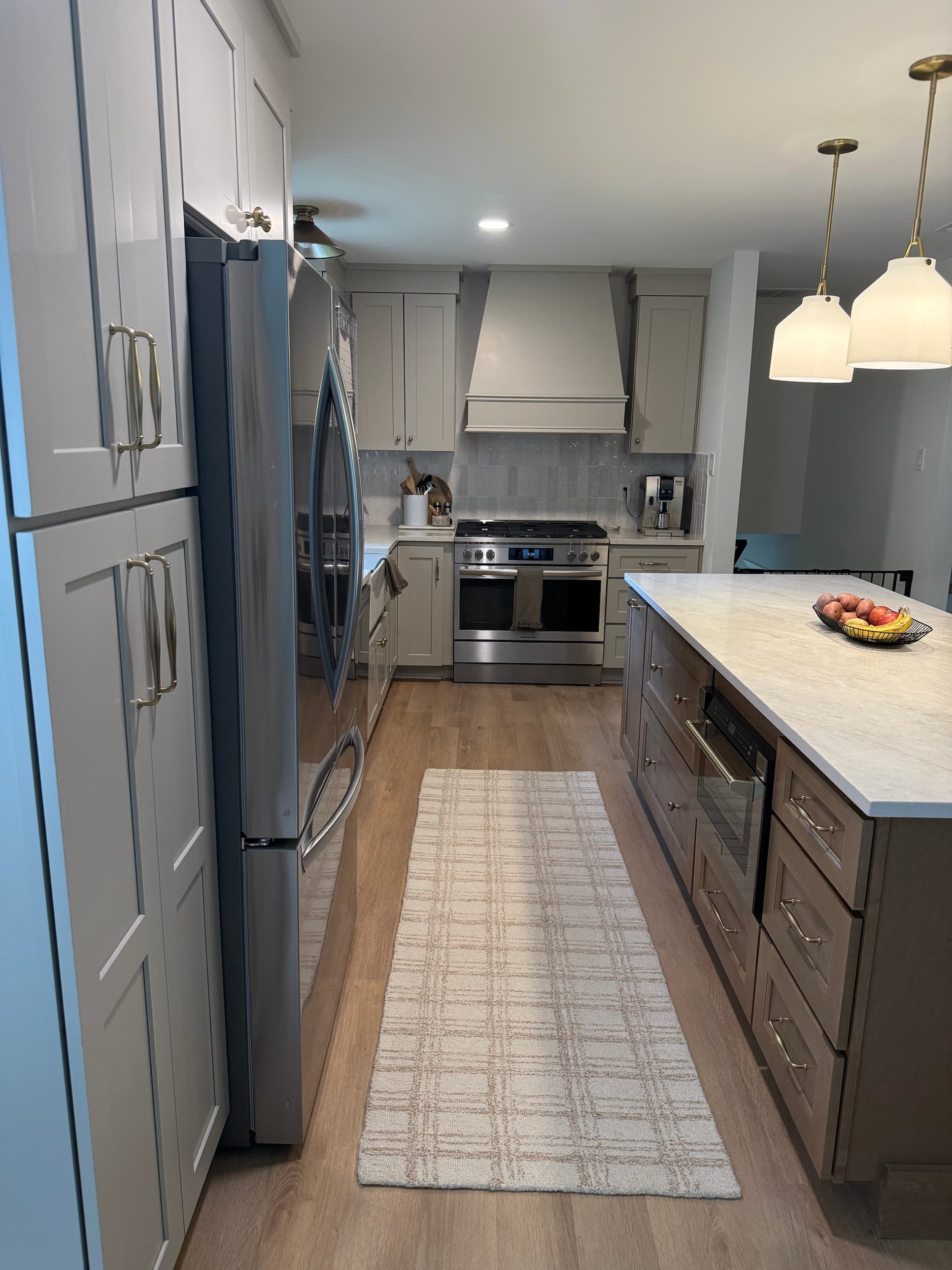 Custom kitchen remodel featuring floor-to-ceiling cabinetry, kitchen island with built-in microwave, and LVP flooring in Charlotte, NC