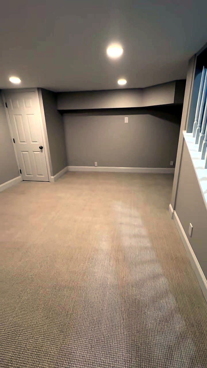 Finished basement in a 1940s Eastover, Charlotte home: new carpet, recessed lighting, drywall and white trim by Remodel CLT