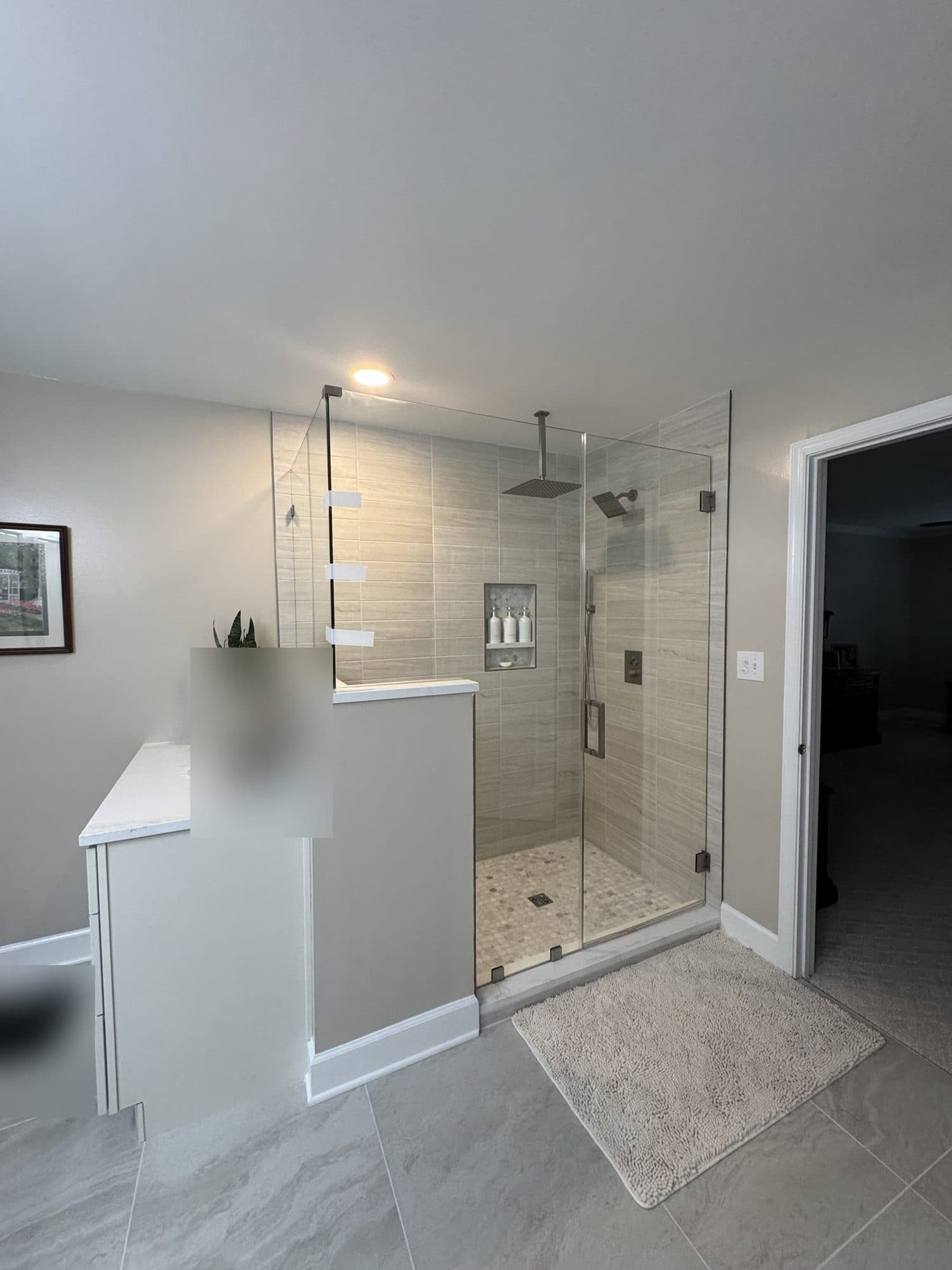 After: corner tub replaced with a large walk-in shower with frameless glass in a Matthews, NC primary bathroom remodel