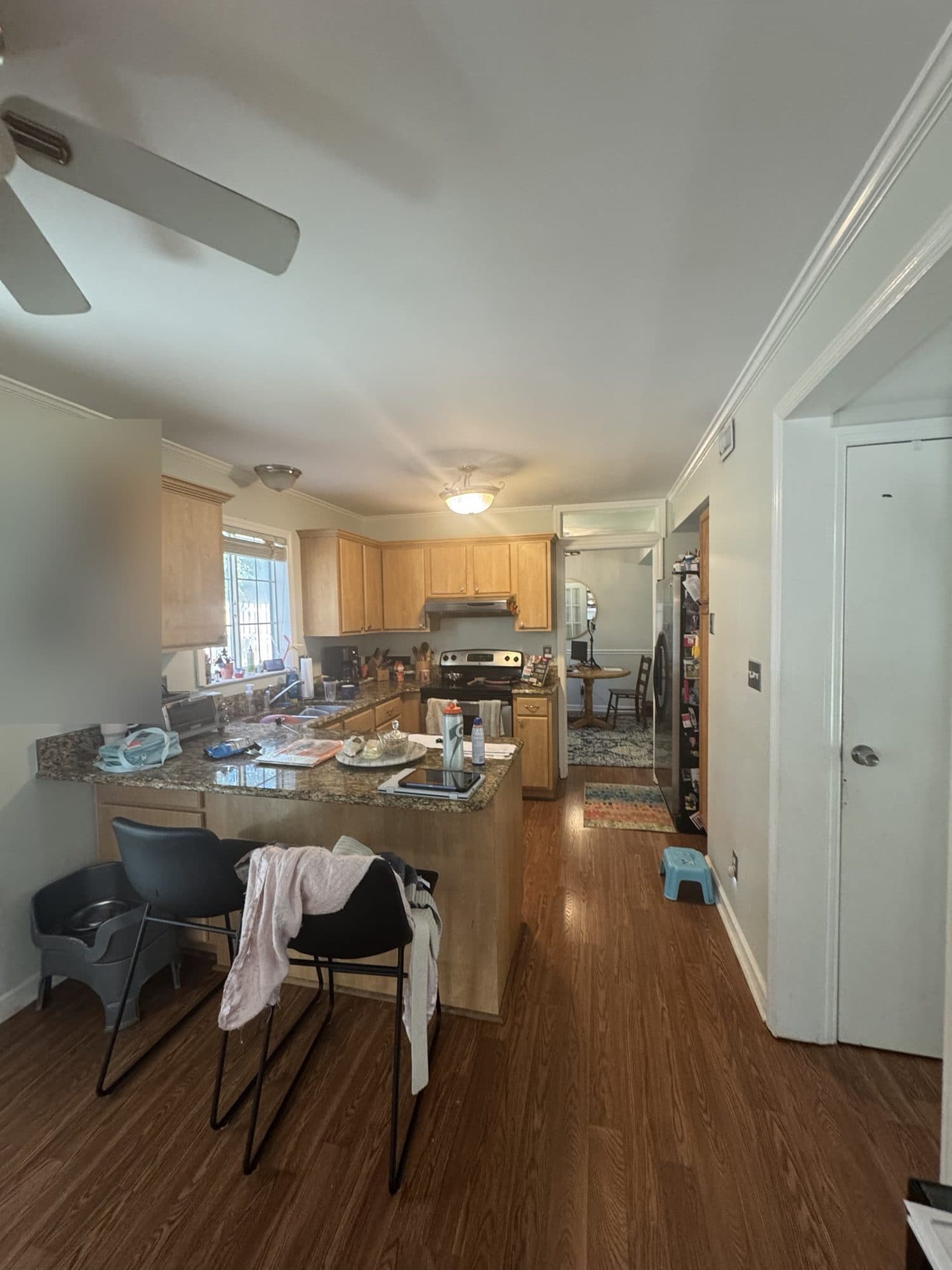 Before: closed-in 1970s kitchen with maple cabinets and granite peninsula in Stonehaven, Charlotte