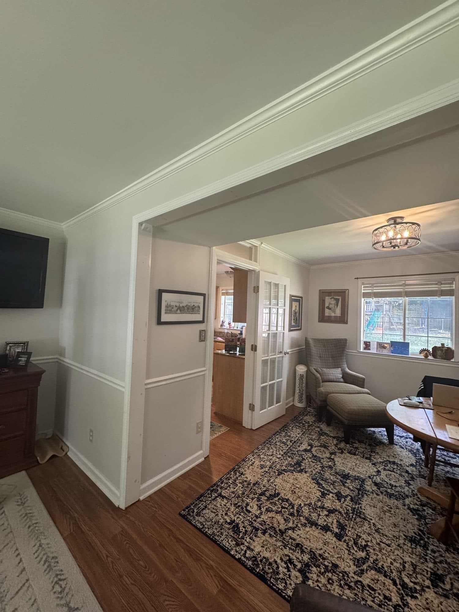 Before: wall and French doors separating the kitchen from the den in a Stonehaven, Charlotte home