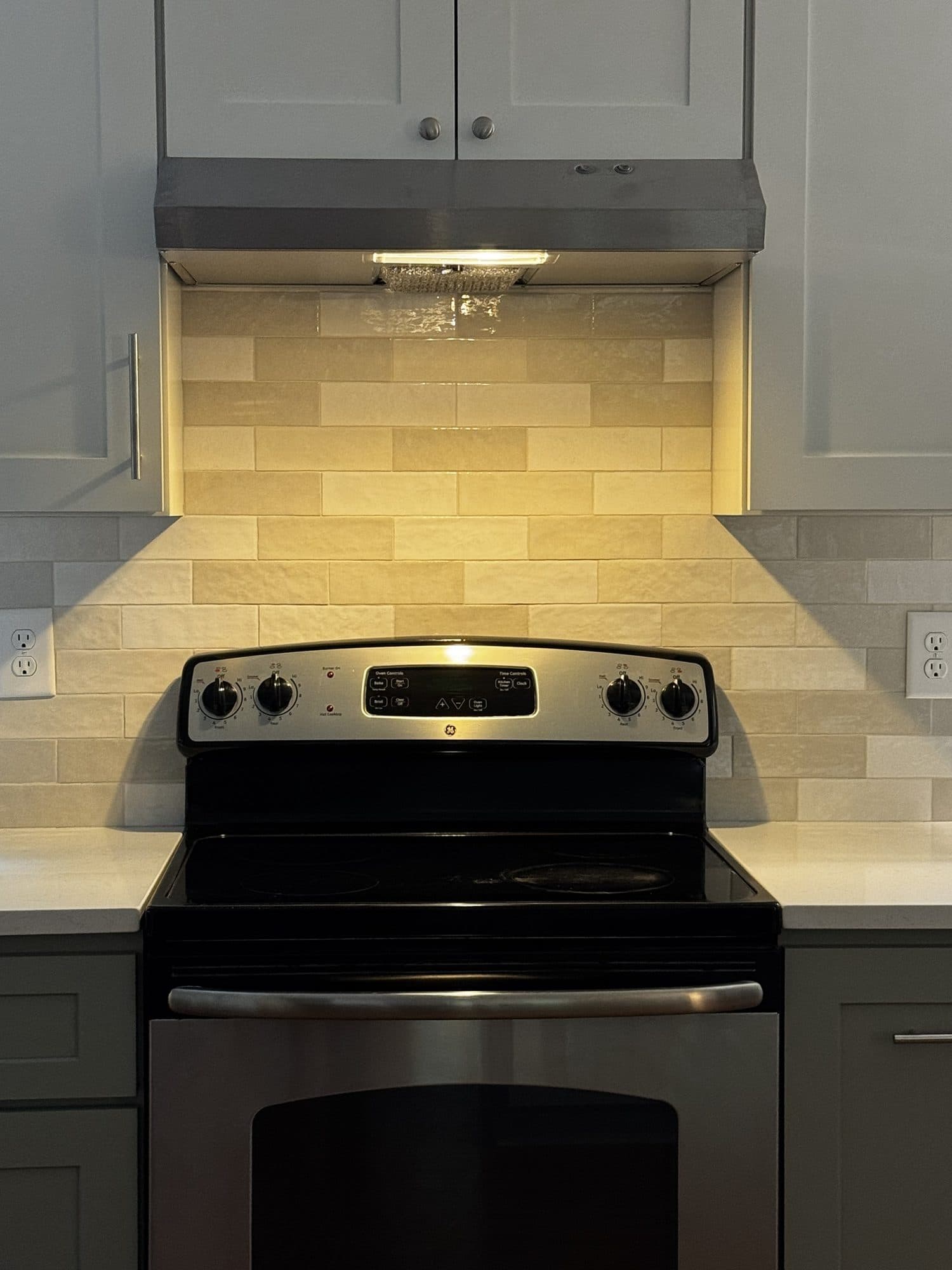 Close-up of handmade-look subway tile backsplash behind the range in a Stonehaven, Charlotte kitchen remodel