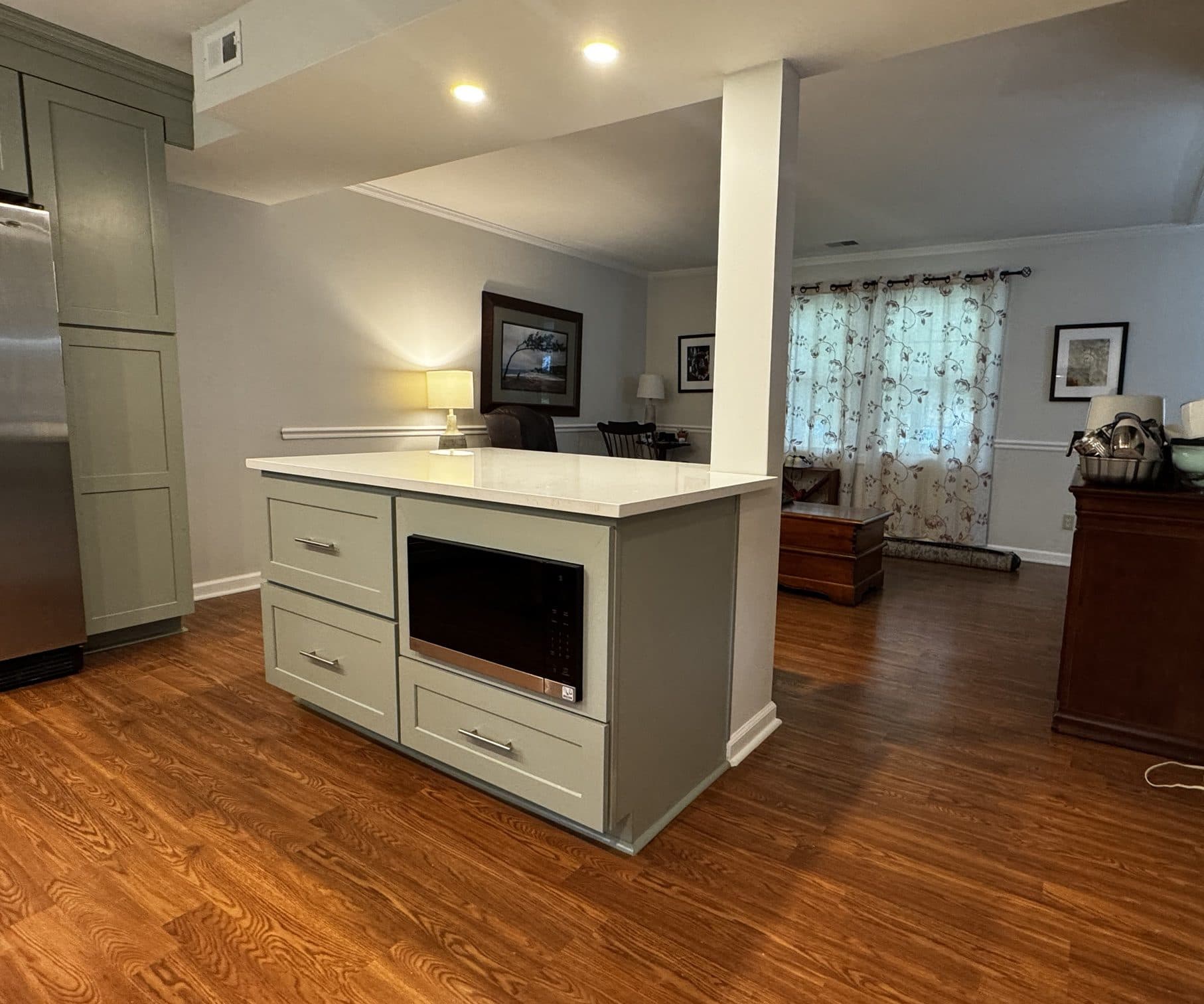 Kitchen peninsula opening into the living room after a wall was removed in a Stonehaven, Charlotte NC home