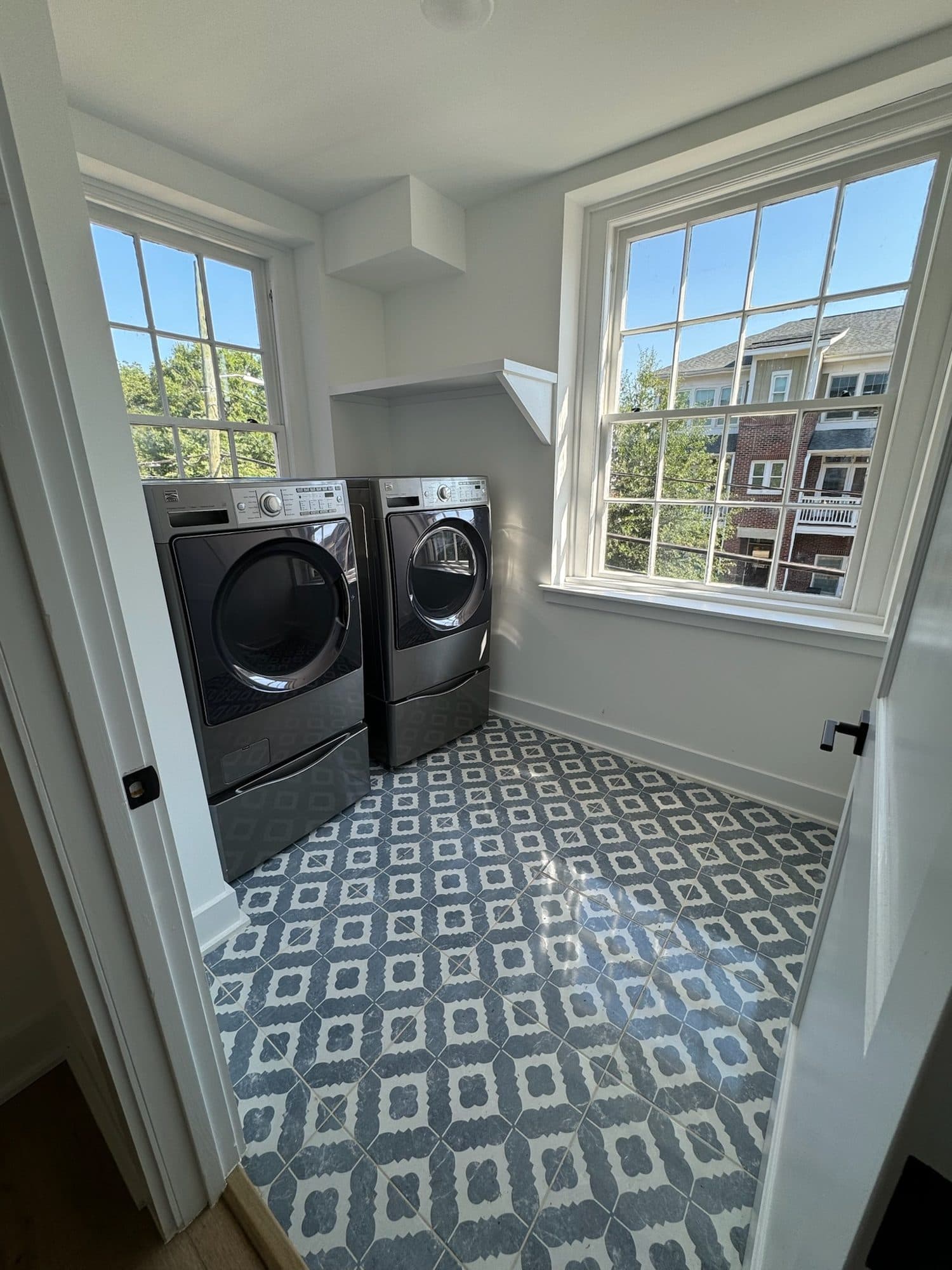 Laundry room with blue-and-white patterned tile floor at The Arches townhomes, Charlotte NC