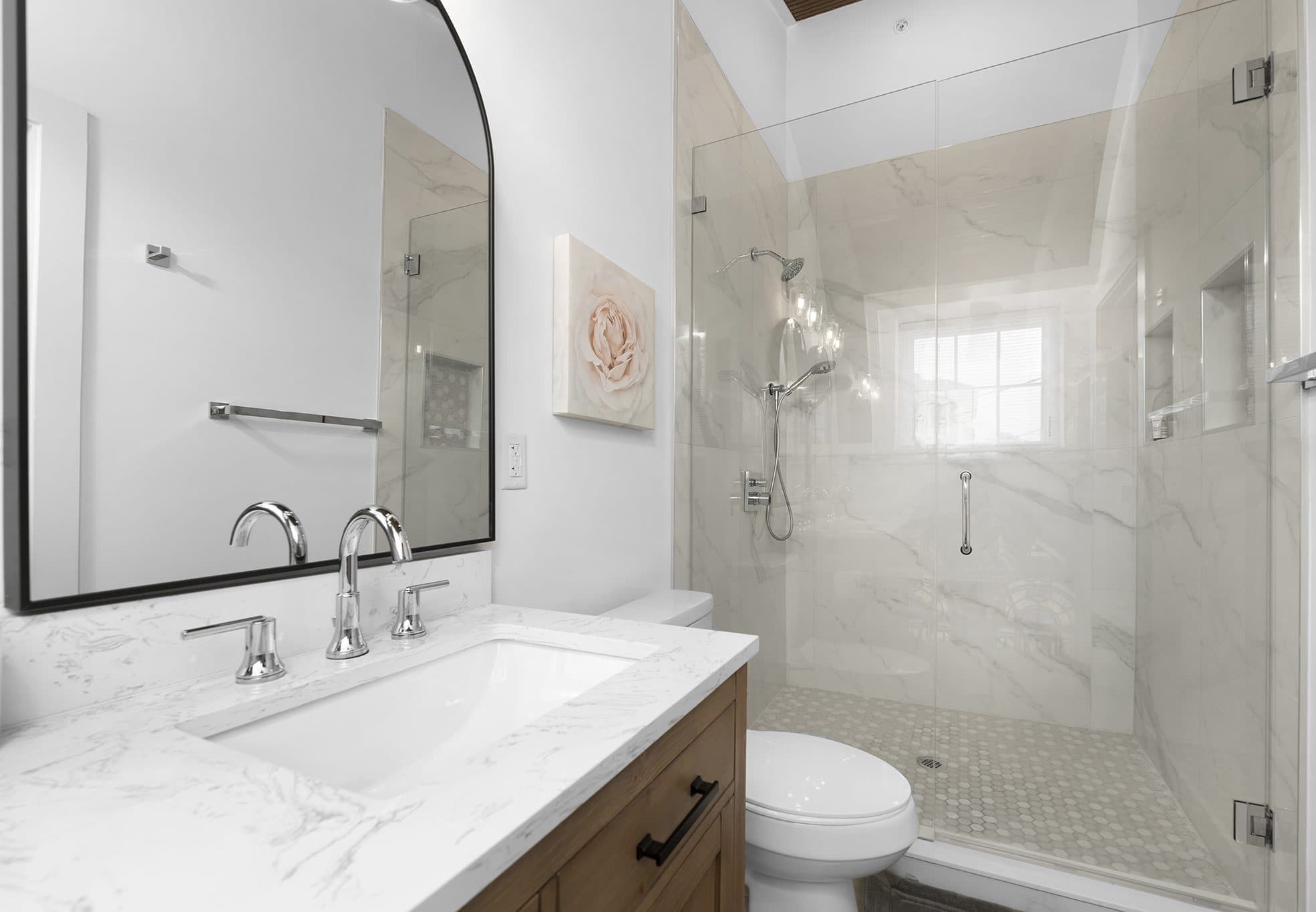 Walk-in shower with frameless glass and hex mosaic floor at The Arches townhomes, Charlotte NC