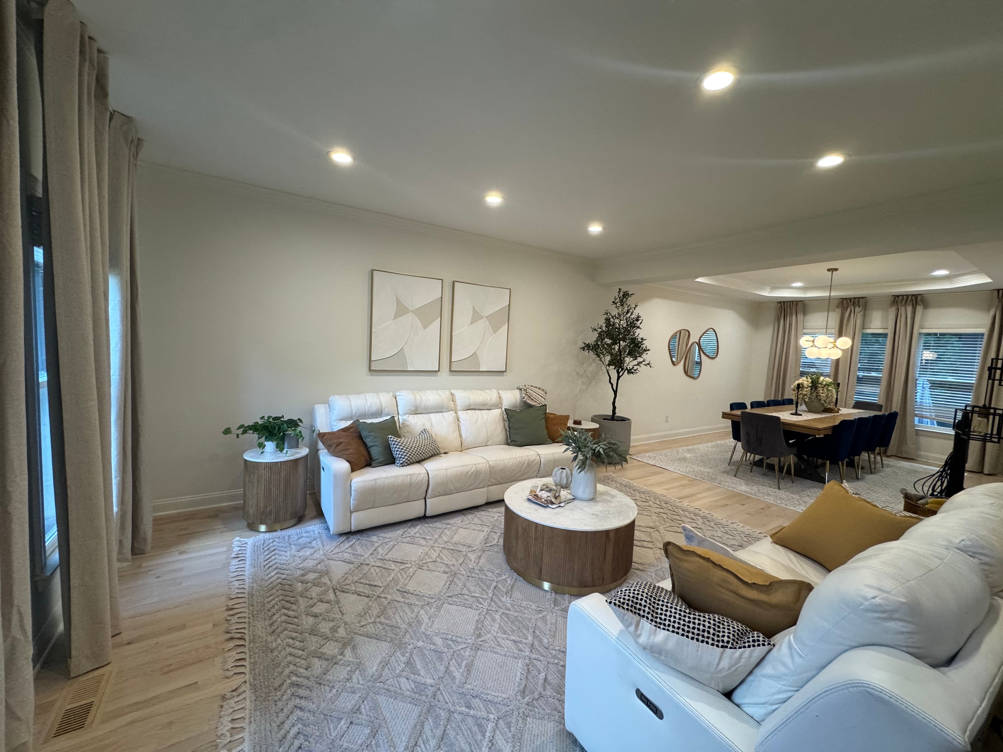 Open plan living and dining remodel in Charlotte with hardwood floors and warm neutral walls.